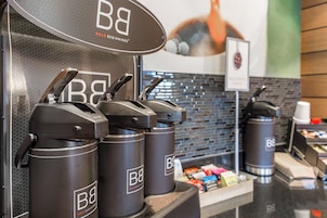 A coffee station with multiple coffee dispensers labeled 'B&B' and a sign indicating 'Bold Beginnings'.