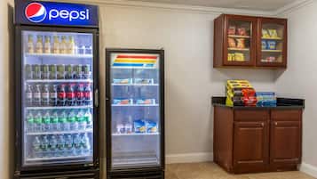 Two beverage vending machines, one with Pepsi and the other with Sprite, and a cabinet with snacks.