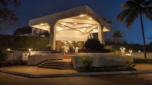 A modern building with a covered entrance, steps leading up to it, and well-lit surroundings. - Trident, Bhubaneswar (Bhubaneshwar)