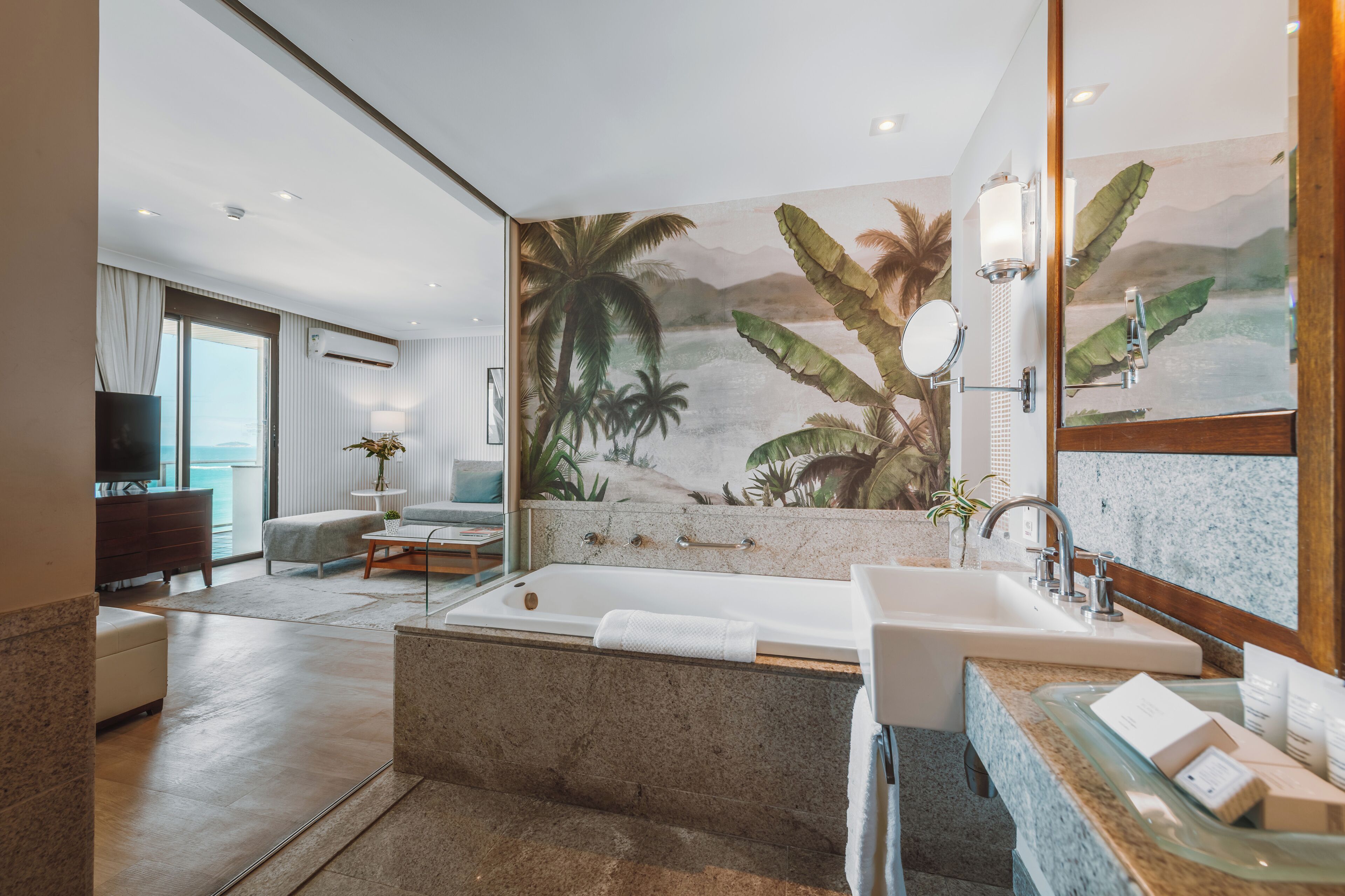 A modern bathroom with a bathtub, sink, and large mirror.