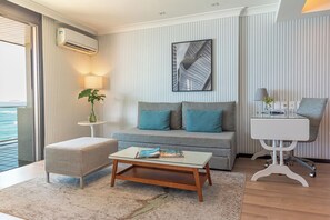 Suite, vistas al mar, frente a la playa | Zona de estar | Smart TV de 43 pulgadas con canales por cable