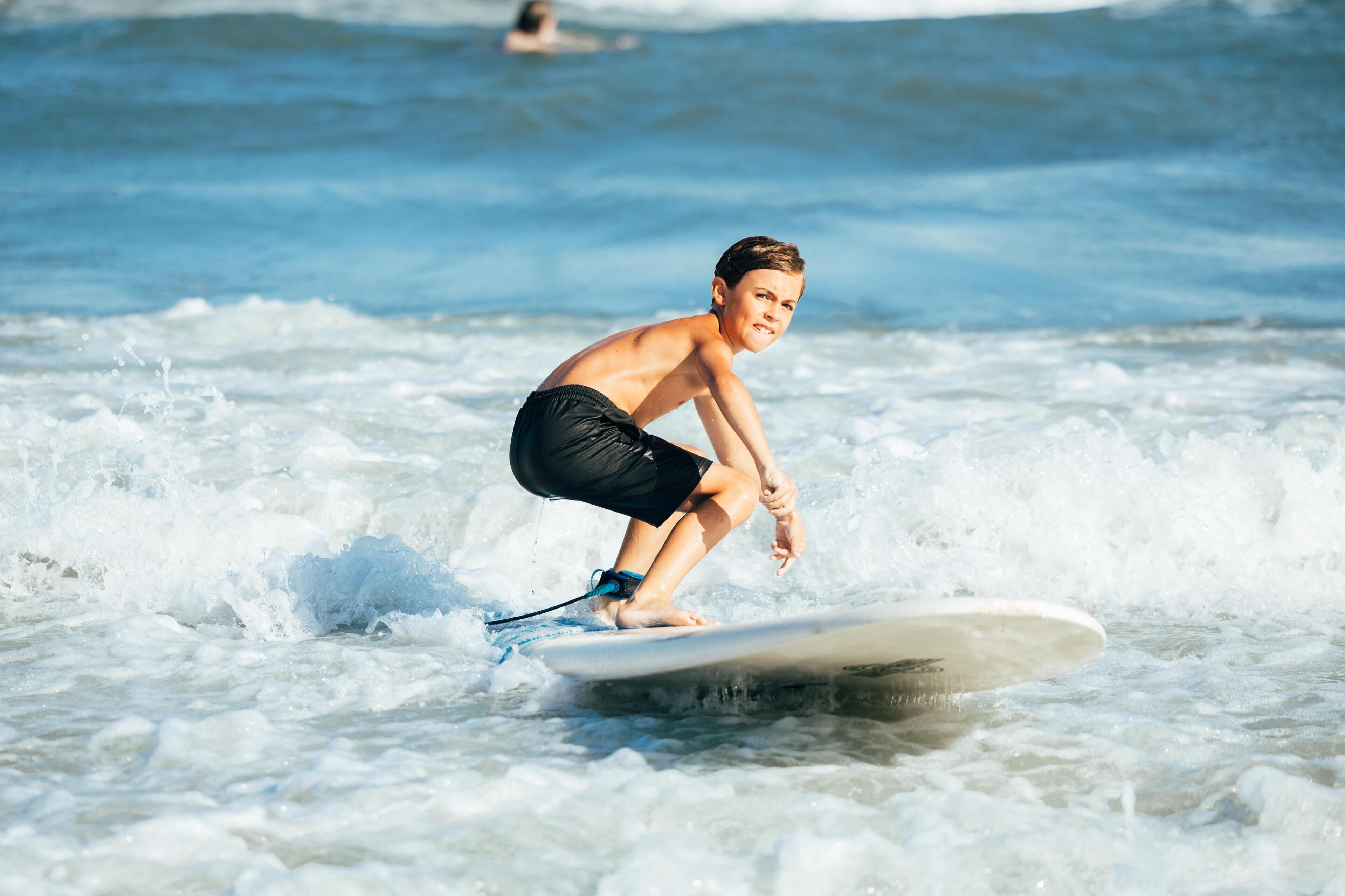 A person surfing on a wave with a surfboard.