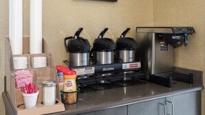 A coffee station with a Bunn coffee machine, disposable cups, and various coffee pods. - Red Roof Inn Columbus East - Reynoldsburg (Columbus)