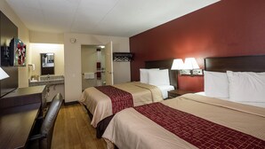 A hotel room with two beds, a desk, and a bathroom. - Red Roof Inn Columbus East - Reynoldsburg (Columbus)