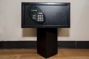 A black electronic keypad mounted on a black pedestal against a wall. - Red Roof Inn Columbus East - Reynoldsburg (Columbus)