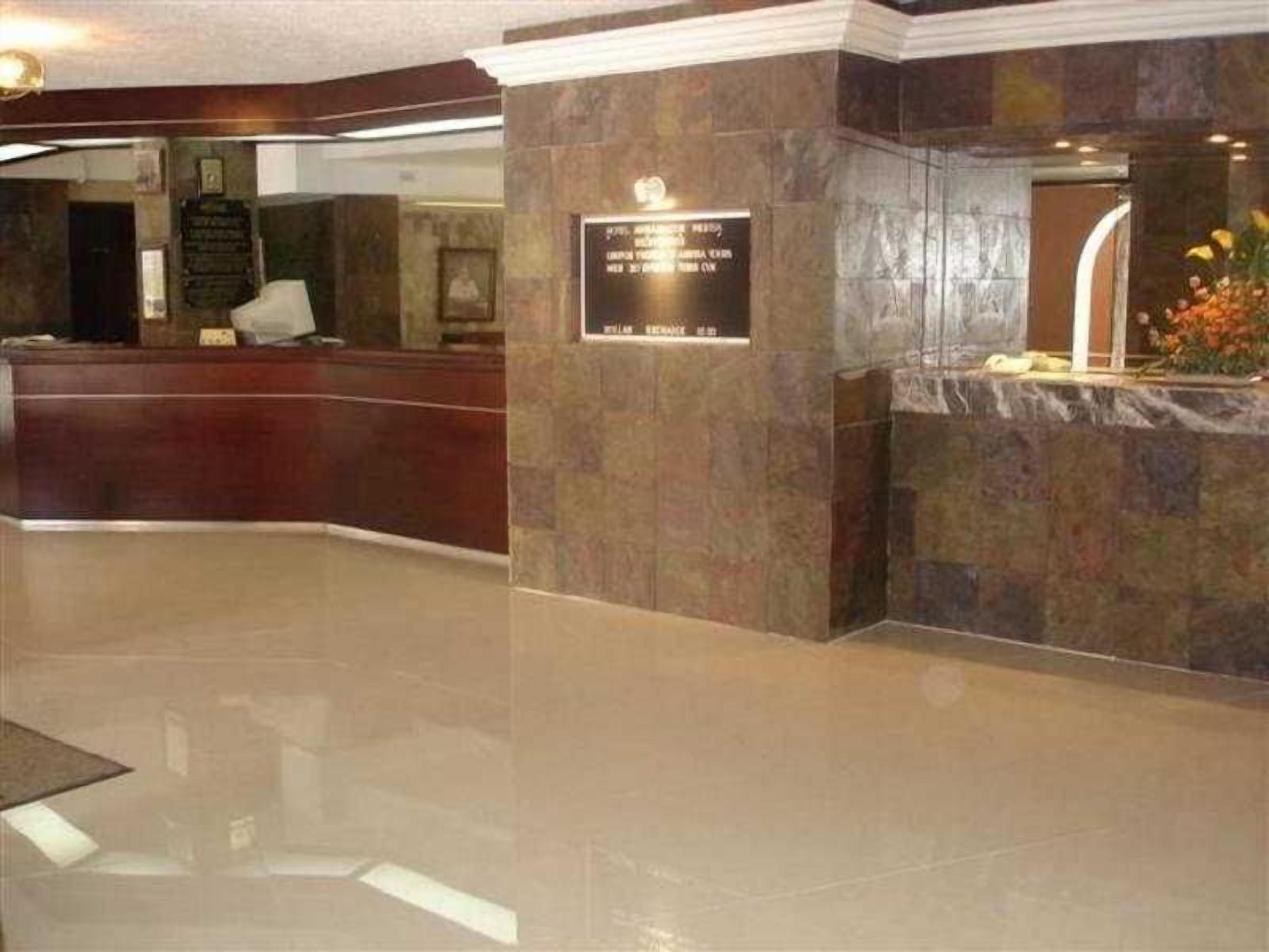 A reception area with a stone wall, a reception desk, and a plaque.