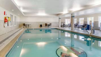 Relax by the pool surrounded by comfortable seating and a serene atmosphere.