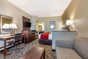 A hotel room with a bed, desk, chair, TV, and a sofa. - Comfort Inn & Suites Orange County John Wayne Airport (Santa Ana)