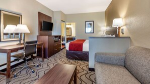 A hotel room with a bed, a desk with a chair, a television, a sofa, and a mirror. - Comfort Inn & Suites Orange County John Wayne Airport (Santa Ana)