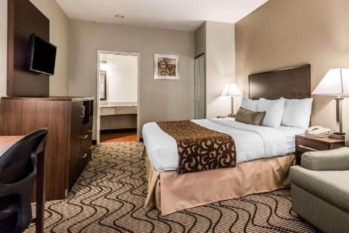 Premium bedding, desk, laptop workspace, blackout drapes
