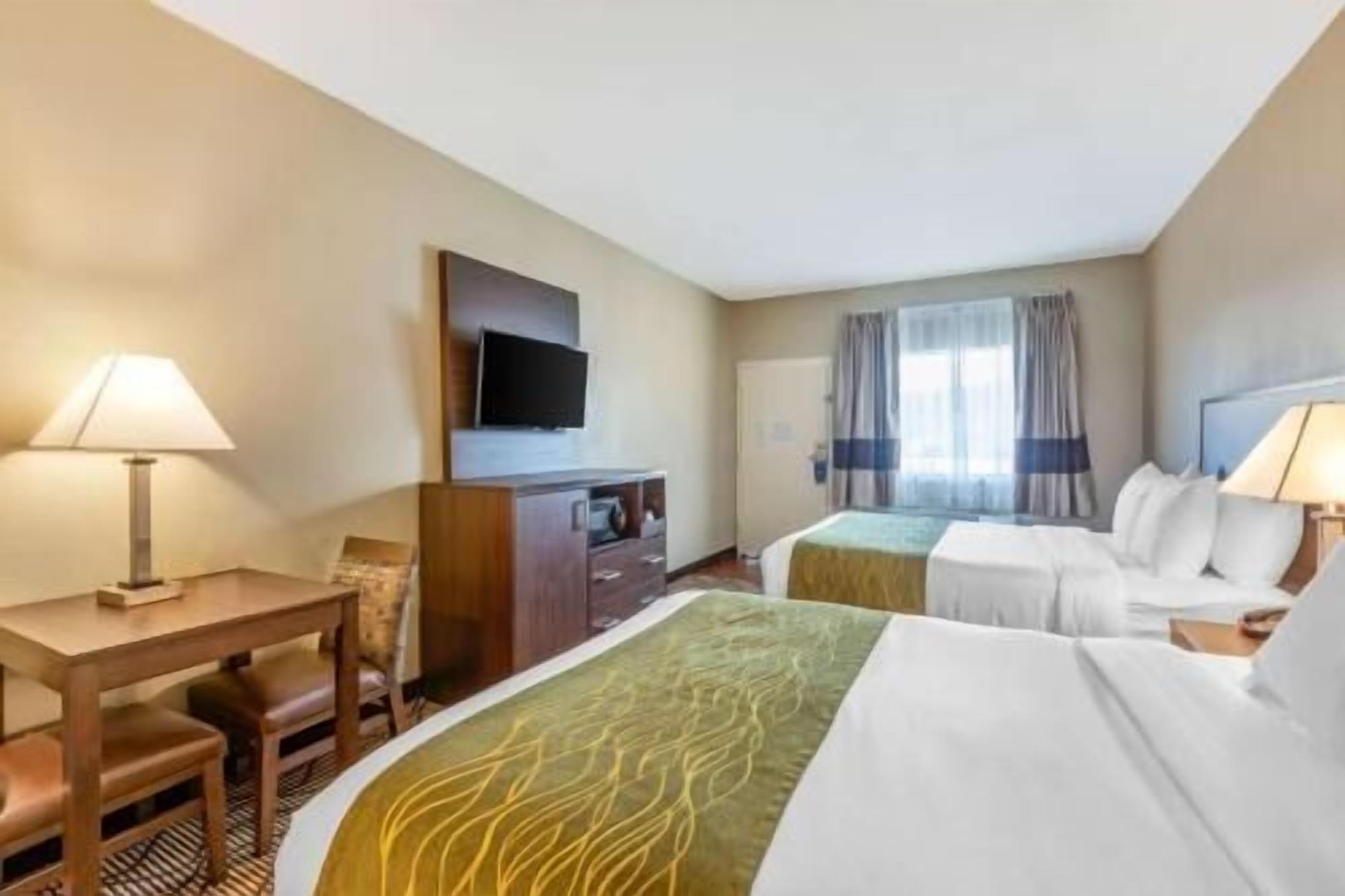 Premium bedding, desk, laptop workspace, blackout curtains