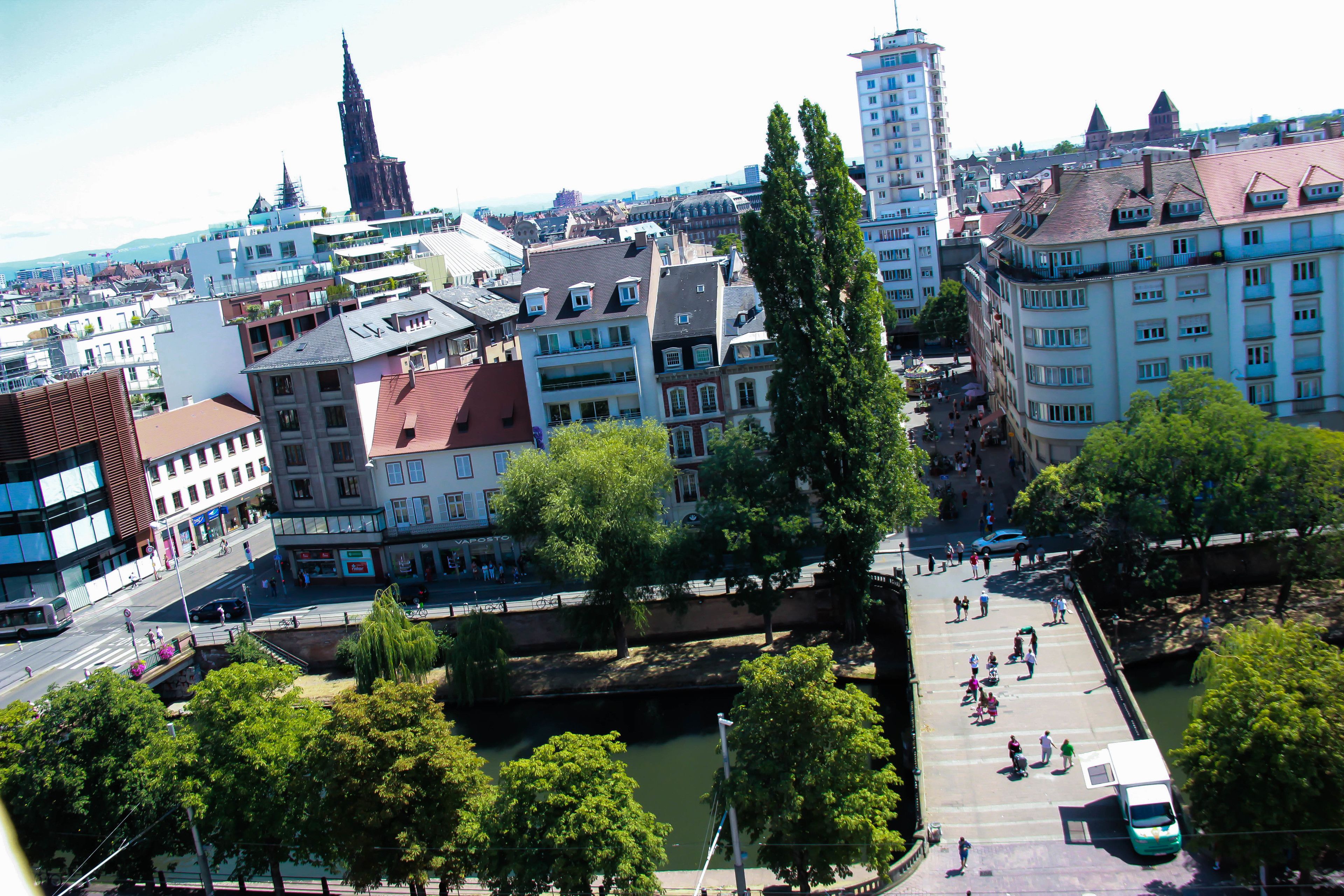 A cityscape with a prominent church spire, a river, and a bridge.