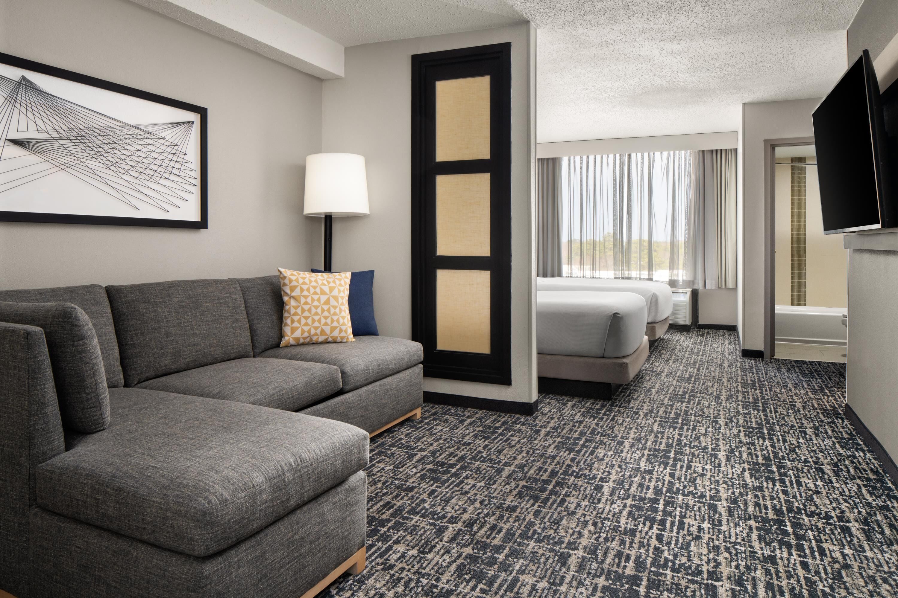 Premium bedding, desk, laptop workspace, blackout curtains