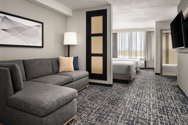Premium bedding, desk, laptop workspace, blackout drapes