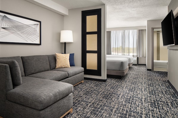 Premium bedding, desk, laptop workspace, blackout drapes