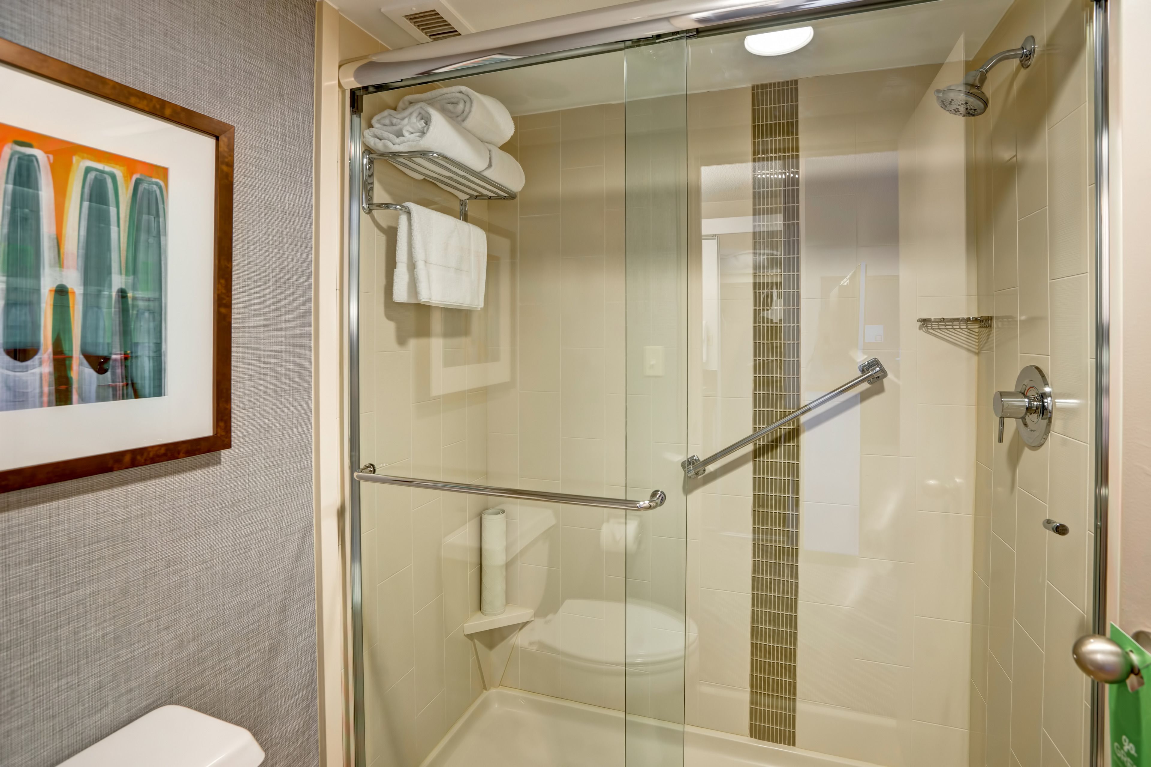 combined shower/bathtub, designer toiletries, hair dryer, towels