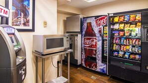 A vending machine with snacks, a microwave, and an ATM. - Red Oak Inn Detroit - Southfield (Southfield)