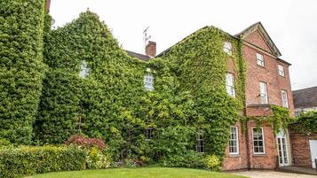 A building with ivy-covered walls and a brick facade.