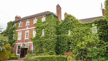 A red brick building with ivy-covered walls and a traditional design.