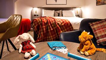 Relax in this inviting space with a plush sofa, comfortable armchair, and neatly made bed.