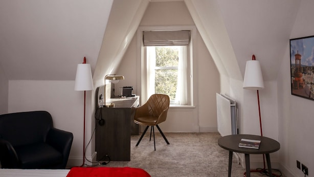 A hotel room with a bed, a desk, a chair, and a small table. - Bruntsfield Hotel, WorldHotels Elite (Edinburgh)