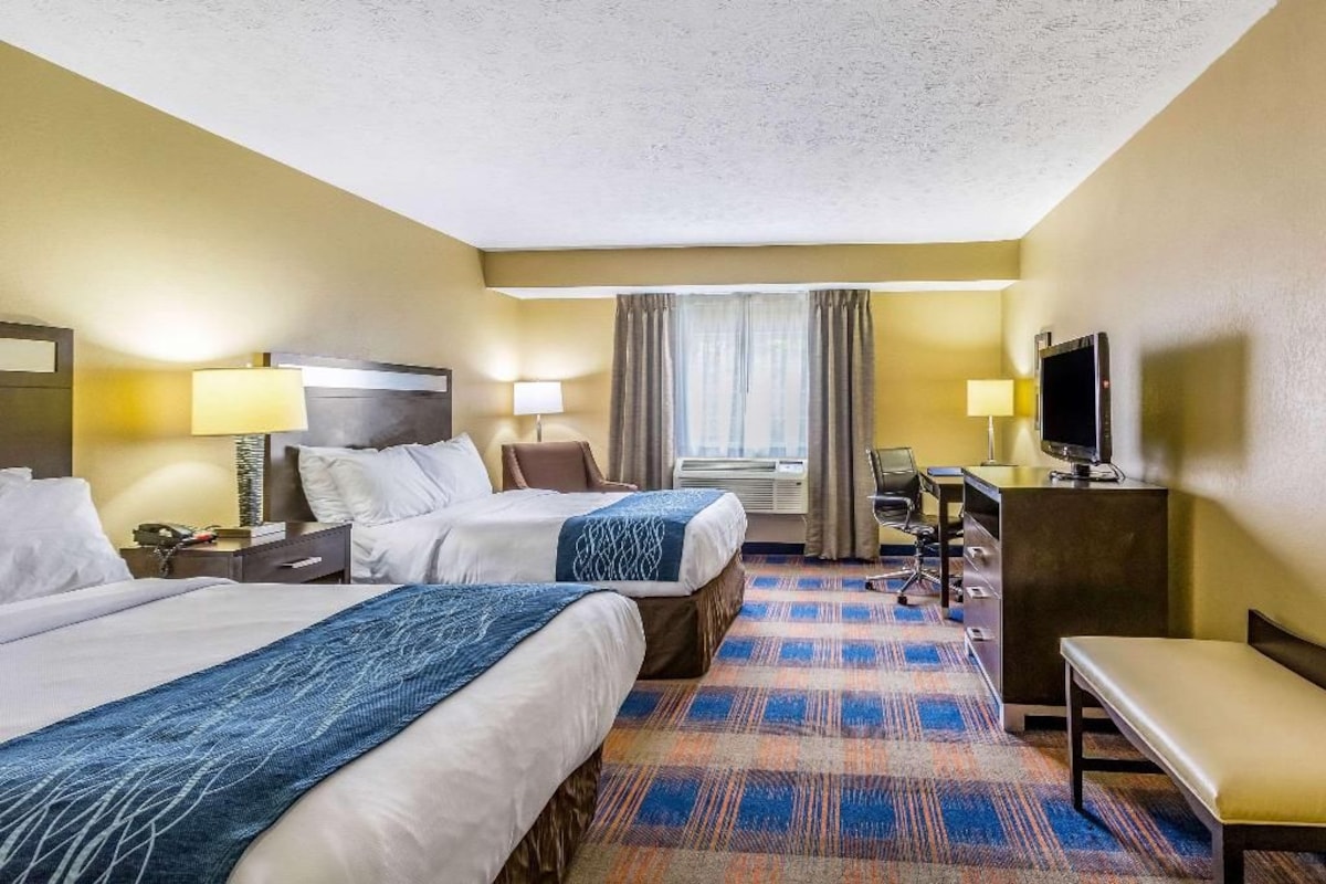 Premium bedding, desk, laptop workspace, blackout drapes