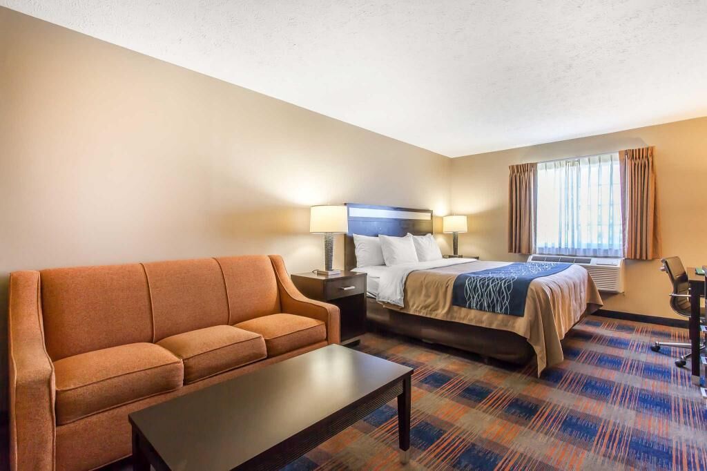 Premium bedding, desk, laptop workspace, blackout drapes