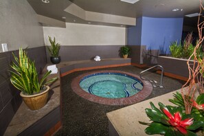 Relax by the pool surrounded by lush greenery and a modern design.