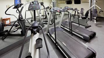 A gym with treadmills, ellipticals, and weight machines.