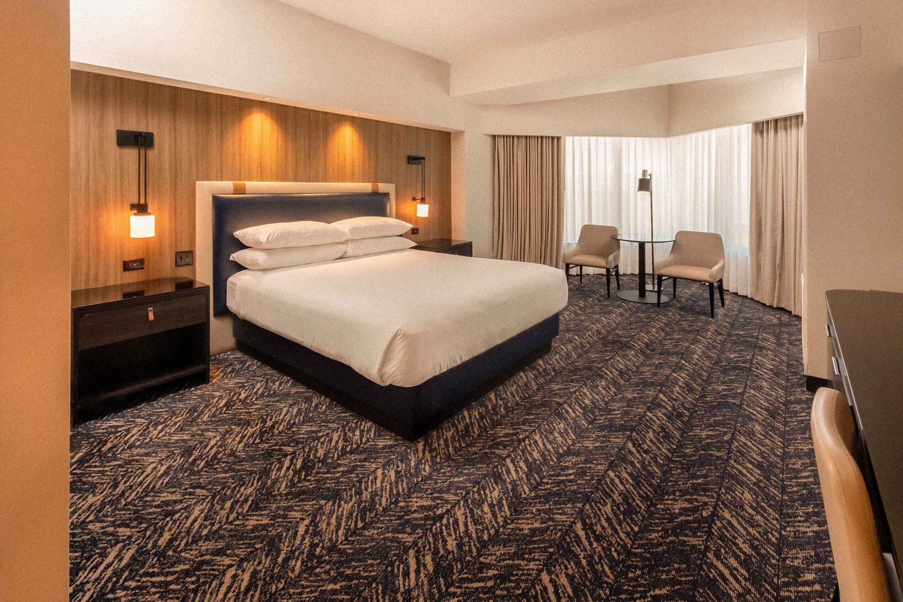 Premium bedding, desk, laptop workspace, blackout curtains