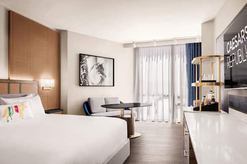 Premium bedding, desk, laptop workspace, blackout drapes