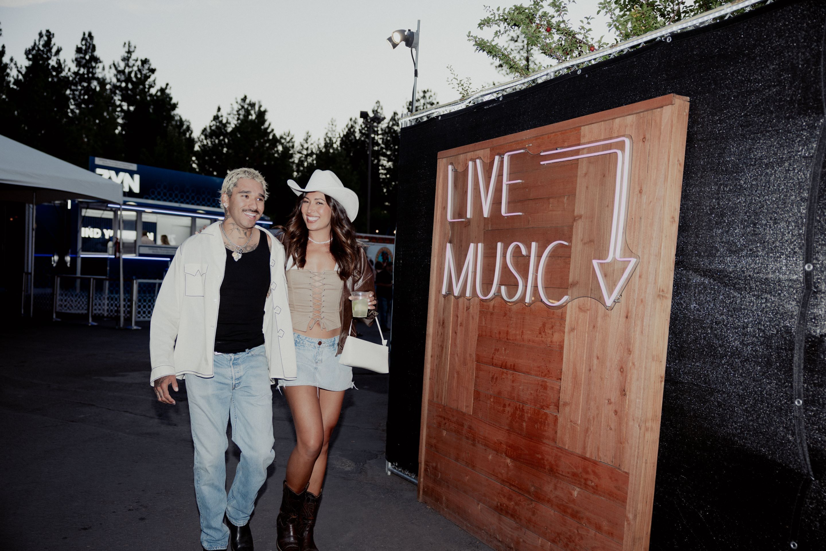 A wooden sign with "LIVE MUSIC" and a downward arrow.