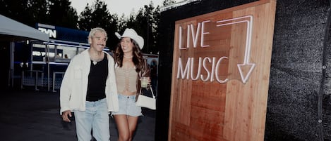 A wooden sign with "LIVE MUSIC" and a downward arrow.