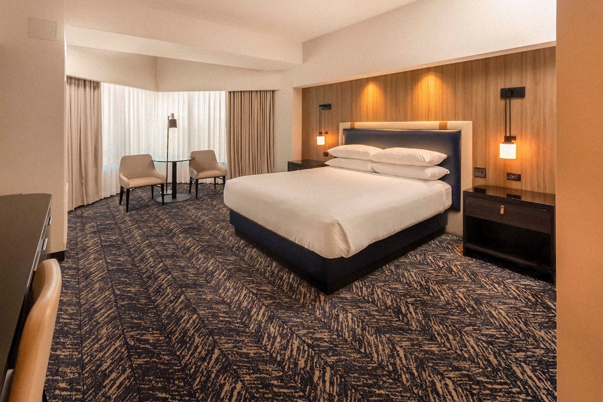 Premium bedding, desk, laptop workspace, blackout curtains