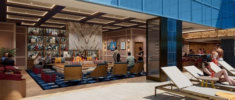A modern lobby with seating areas, a fireplace, and a bar/lounge area.