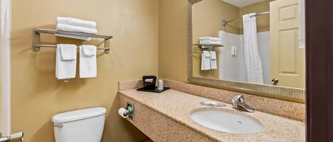 A bathroom with a toilet, sink, and towel rack.