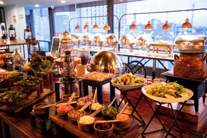 A buffet setup with various food items and serving utensils. - Hotel Fontan Reforma Centro Histórico (Mexico City)