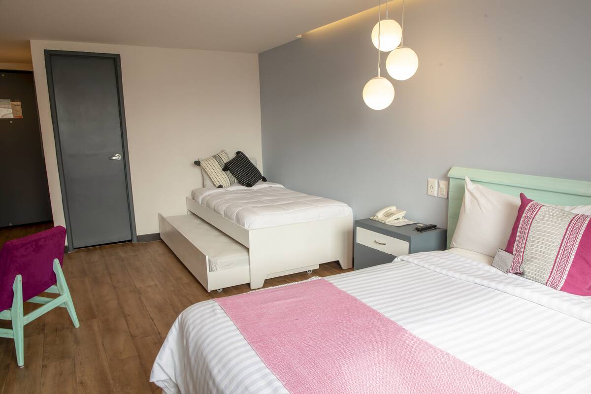 A modern bedroom with a bed, bedside table, and a chair.
