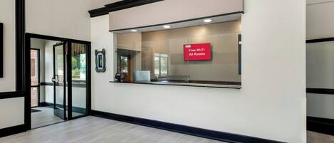 A reception area with a sign indicating free Wi-Fi in all rooms.