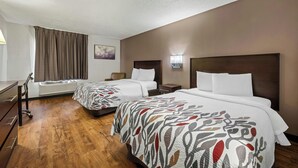 A hotel room with two beds, a desk, and a chair. - Red Roof Inn Charlotte - University (Charlotte)