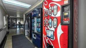 Vending machines with various beverage options in a hallway. - Red Roof Inn Charlotte - University (Charlotte)