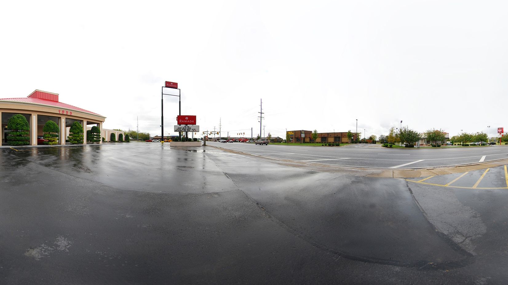 A parking lot with a building labeled "RAMADA" in the background.