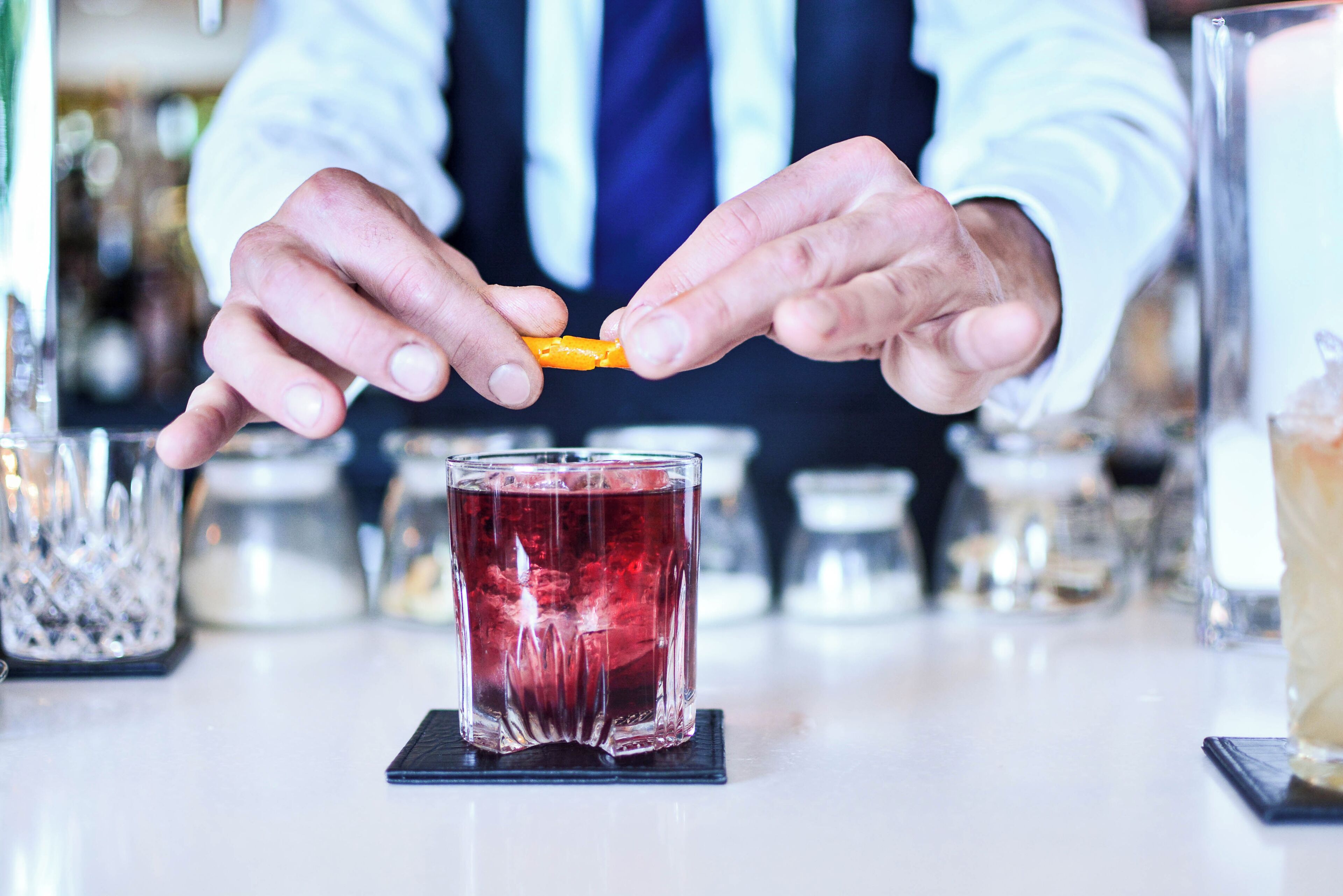 A person pouring a drink into a glass.