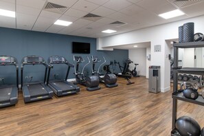A gym with treadmills, elliptical machines, and a weight rack. - Hilton London Gatwick Airport (Gatwick)