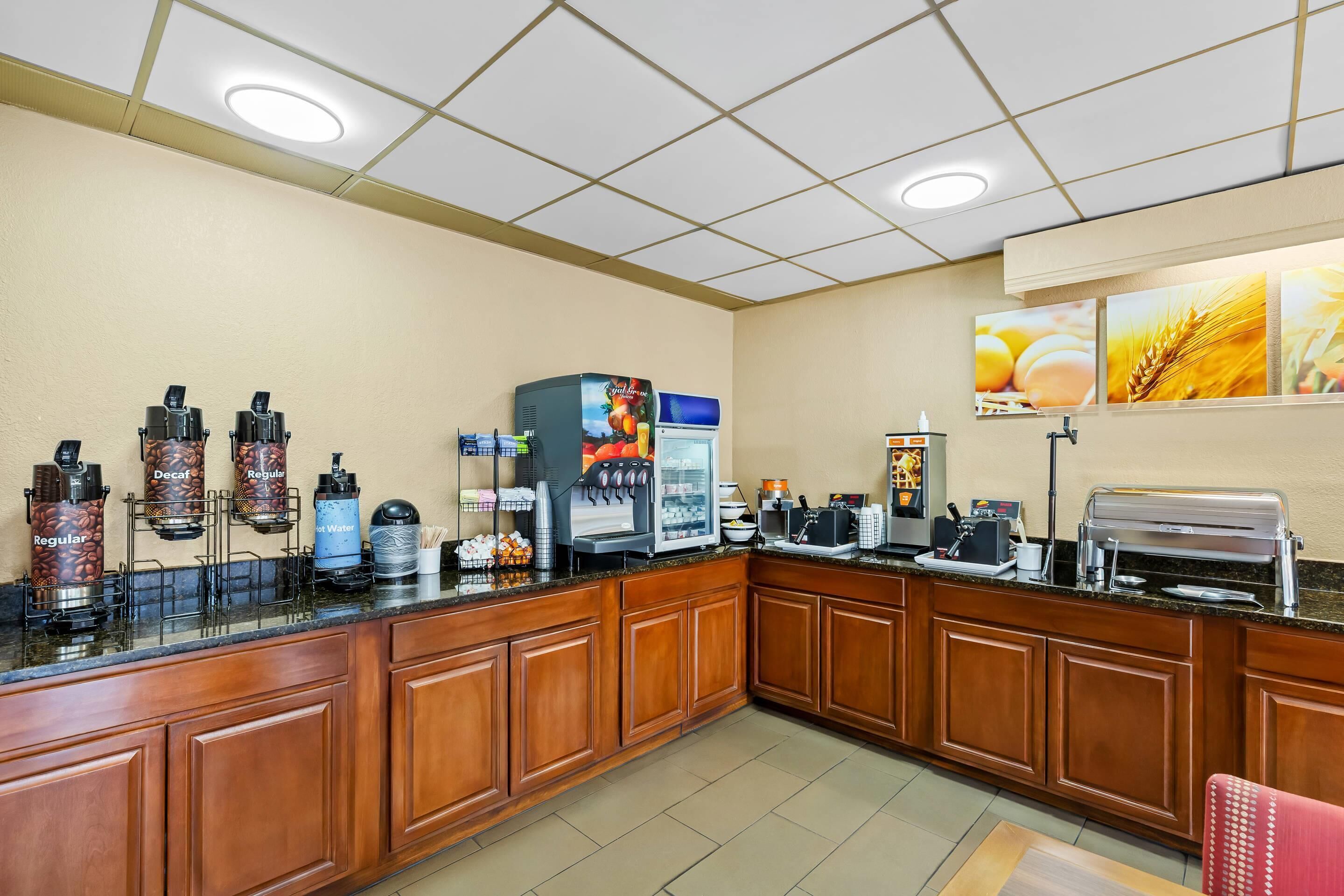A breakfast bar with coffee machines, a water dispenser, and a toaster.