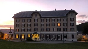 A multi-story hotel with a symmetrical facade, multiple windows, and a central entrance. - Best Western Grand Hotel de Paris & Spa (Villard-de-Lans)