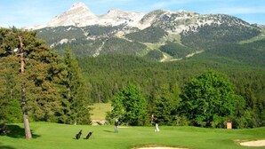 A golf course with a mountainous backdrop, trees, and a clear sky. - Best Western Grand Hotel de Paris & Spa (Villard-de-Lans)