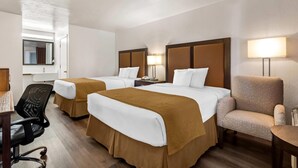 A hotel room with two beds, a desk, a chair, and a lamp. - Travelodge by Wyndham Page, View of Lake Powell (Page)