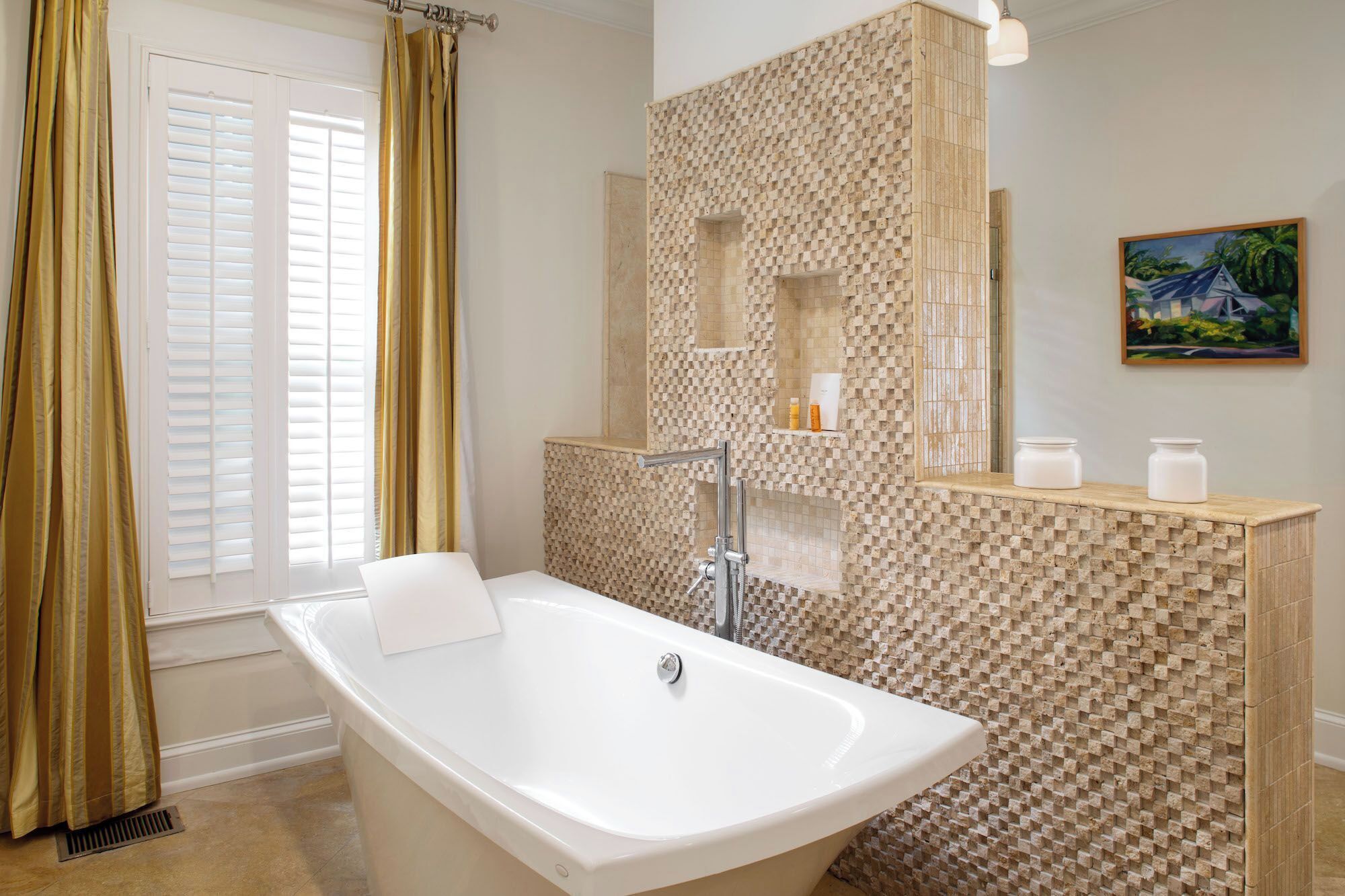 A bathroom with a freestanding bathtub, a shower area with a textured wall, and a vanity with a mirror and shelves.