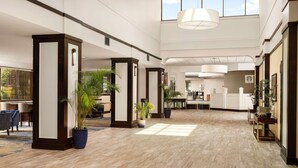 A spacious hotel lobby with high ceilings, large windows, and modern furnishings. - DoubleTree by Hilton Williamsburg (Williamsburg)